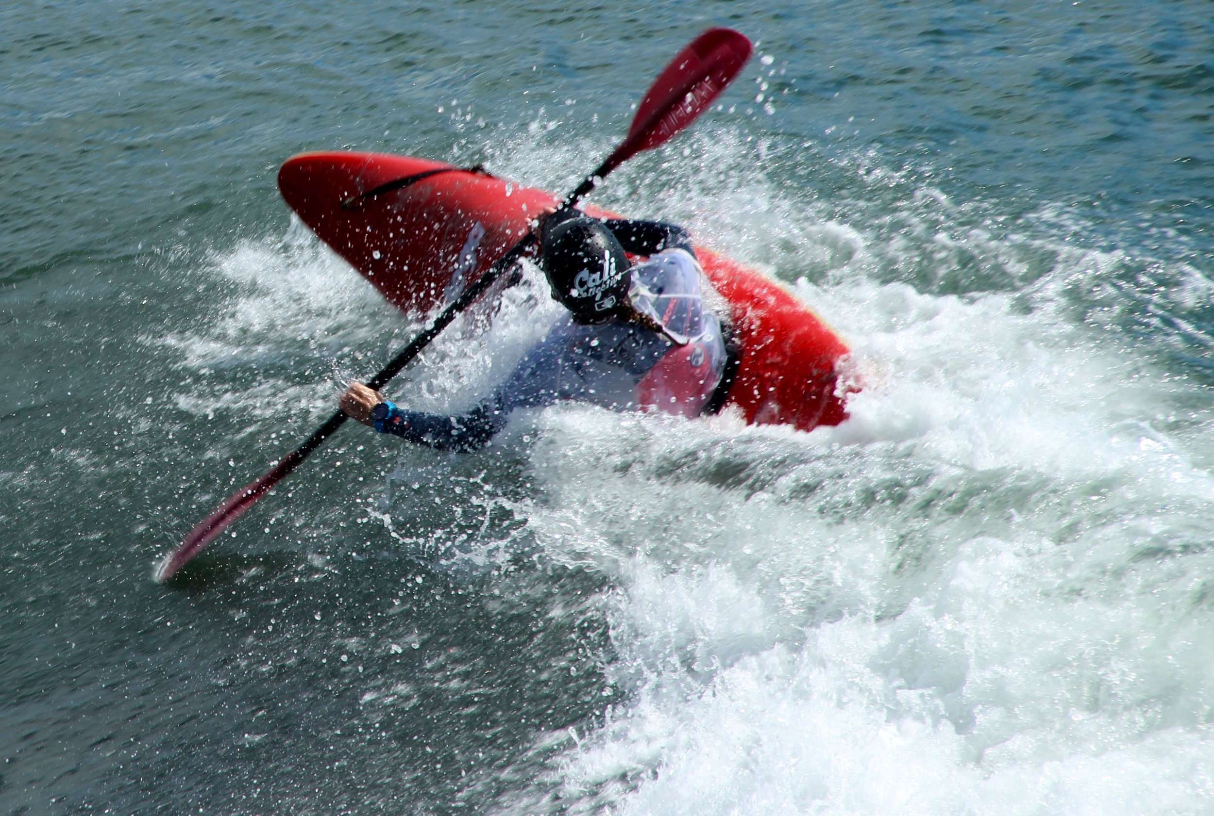 a man riding a wave on top of a body of water