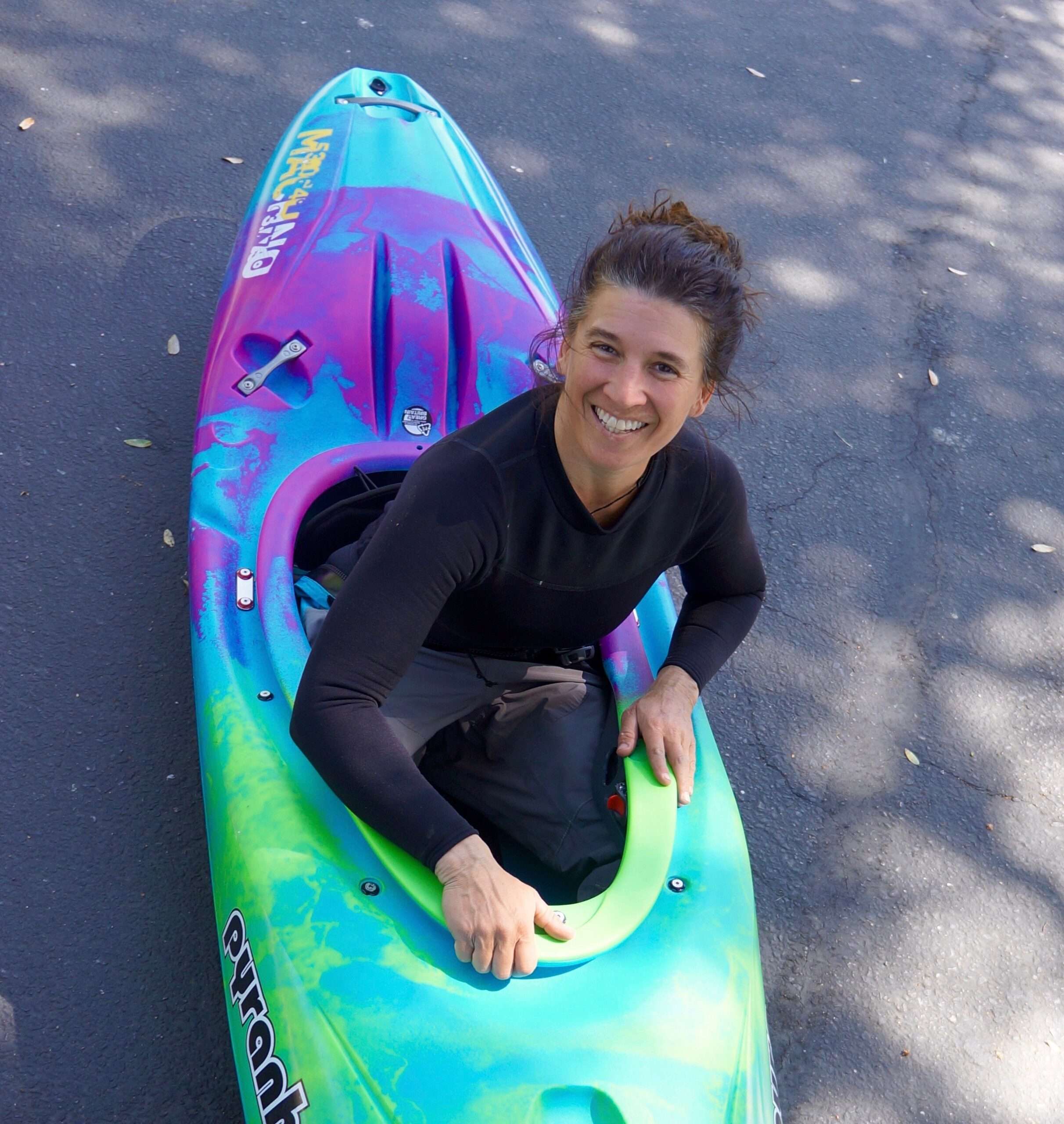 a young man wearing a wet suit holding a surfboard