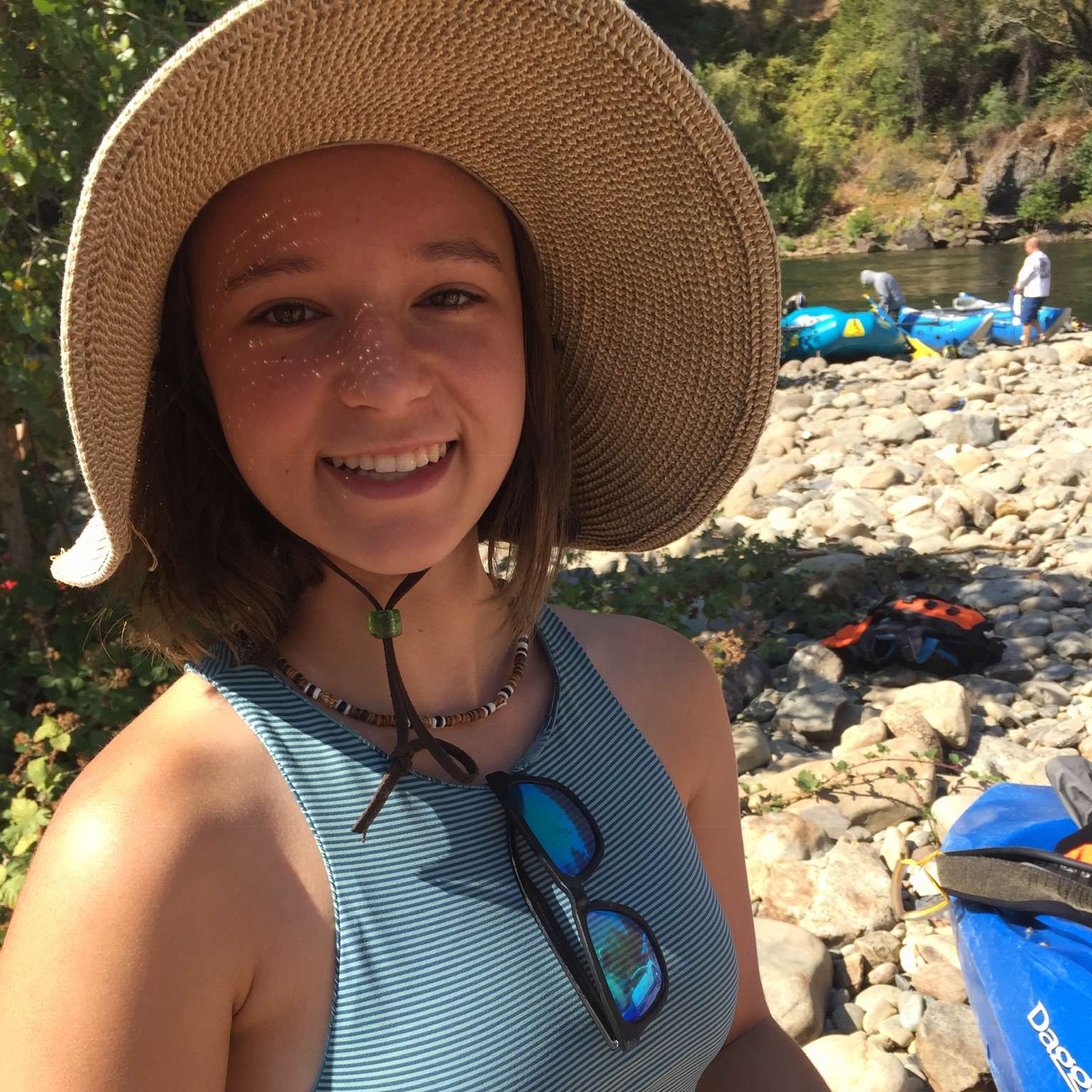 a woman wearing a hat and smiling at the camera