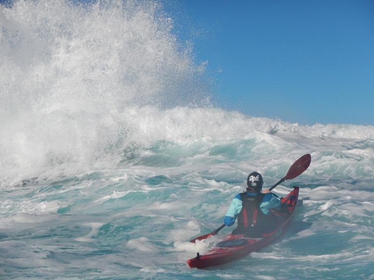 a man riding a wave on a surfboard in the water