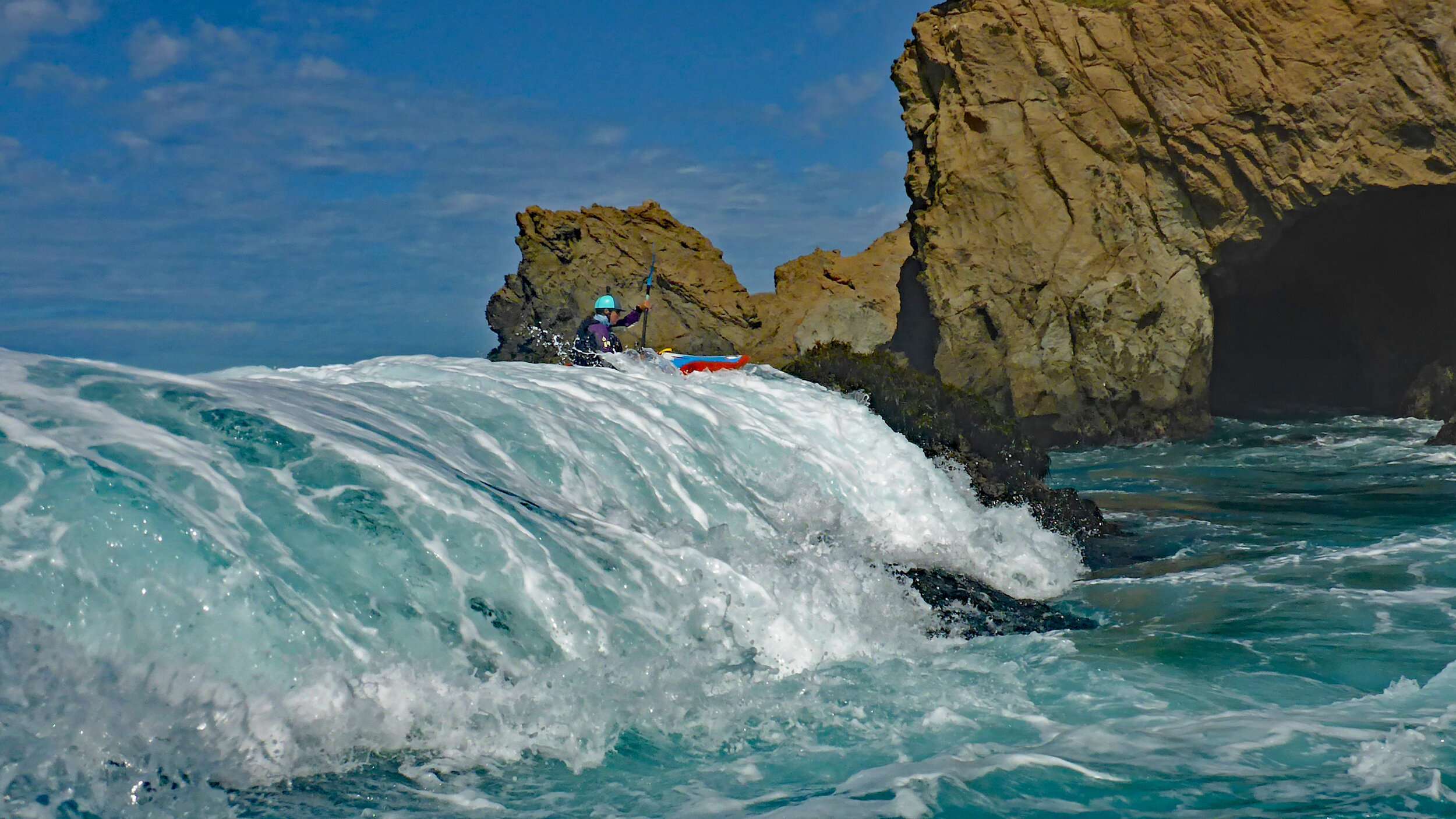 a man riding a wave on top of a mountain