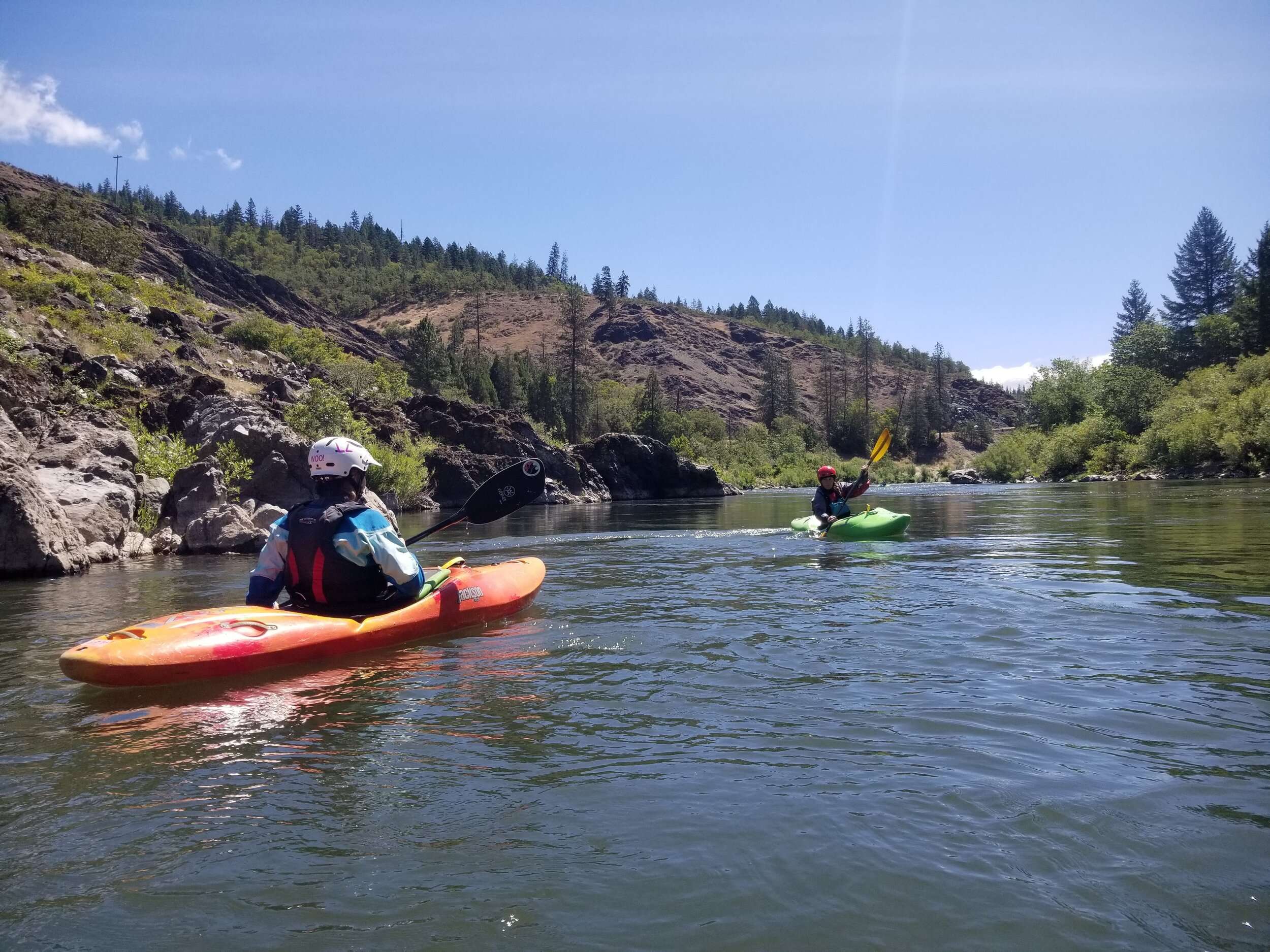 a group of people in a small boat in a body of water