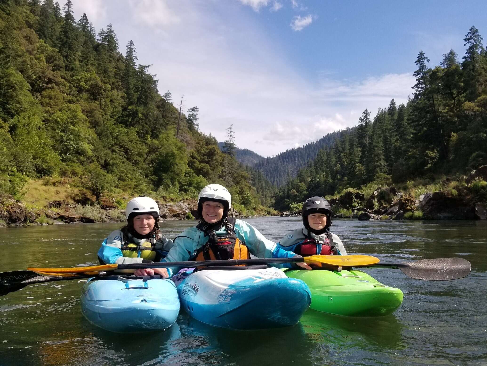 a group of people riding on the back of a boat in the water