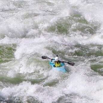 a man riding a wave on a surf board on a body of water