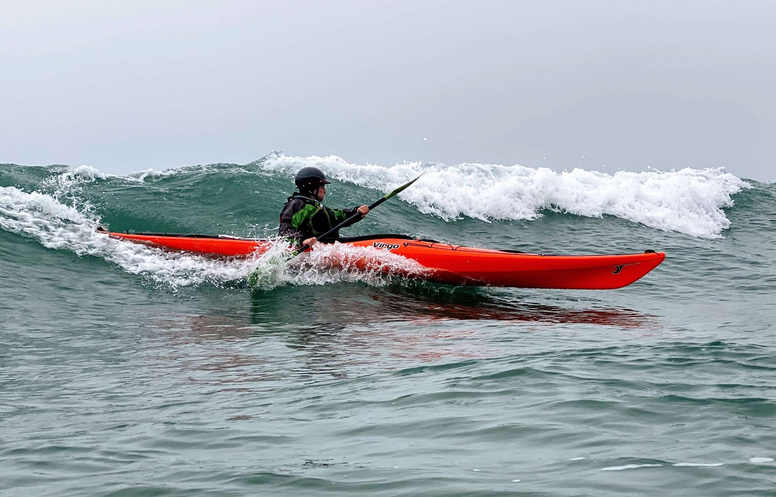 a small girl riding a wave on a surfboard in the ocean