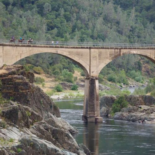 a train crossing a bridge over a body of water