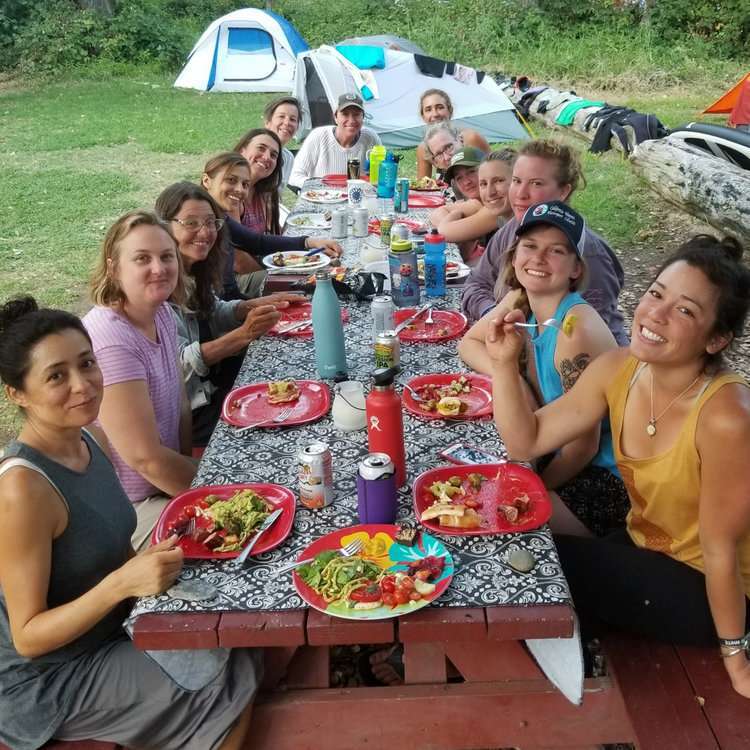 a group of people sitting at a picnic table