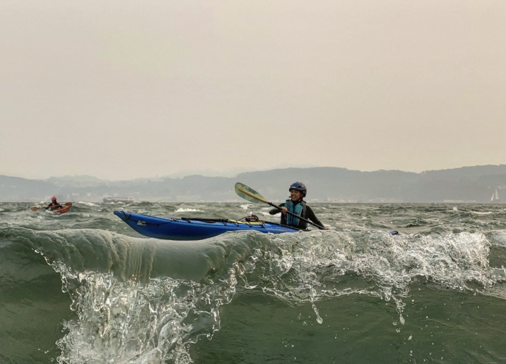 a man and a woman riding a wave on a surfboard in the ocean