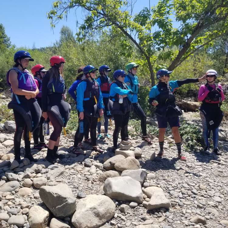 a group of people standing on a rock