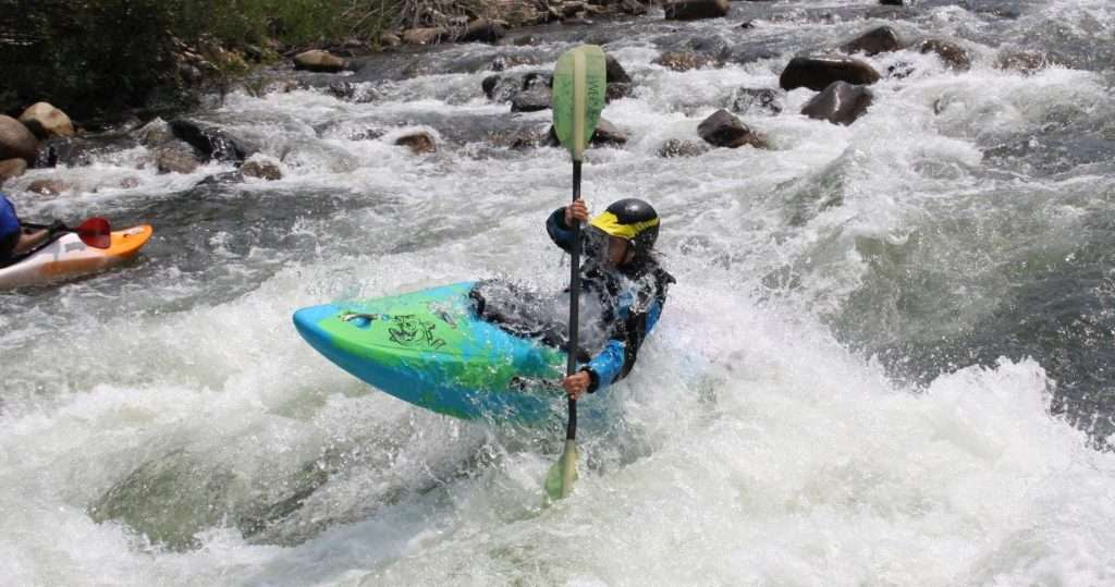 a person riding a wave on a surf board on a body of water