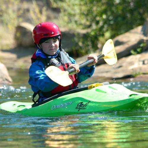 a person riding on the back of a boat in the water