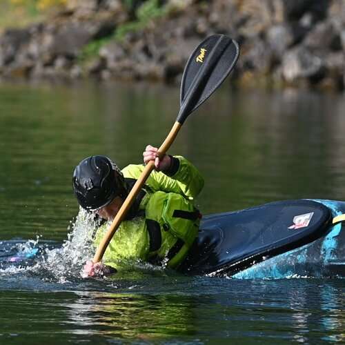 a person rowing a boat in a body of water