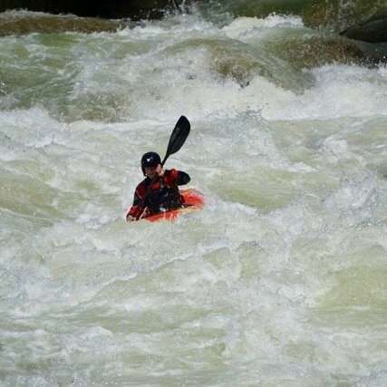 a person riding a wave on a surfboard in the water