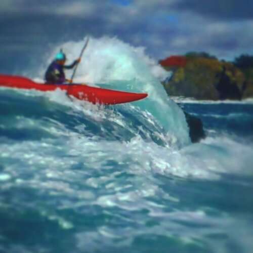 a man riding a wave on top of a body of water