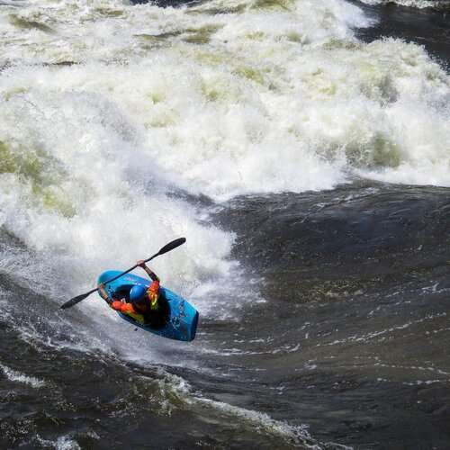 a person riding a wave on top of a body of water