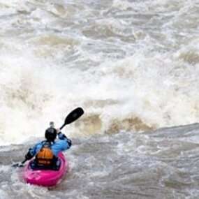 a person riding a wave on top of a body of water