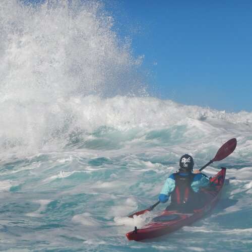 a man riding a wave on a surfboard in the water