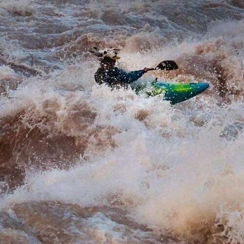 a person riding a wave on top of a body of water