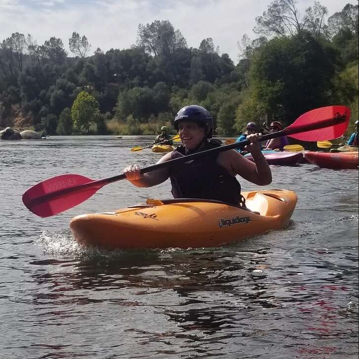 a person riding on the back of a boat in the water