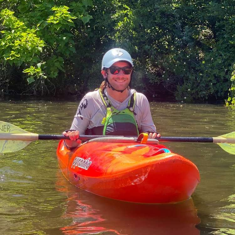 a person riding on the back of a boat in the water