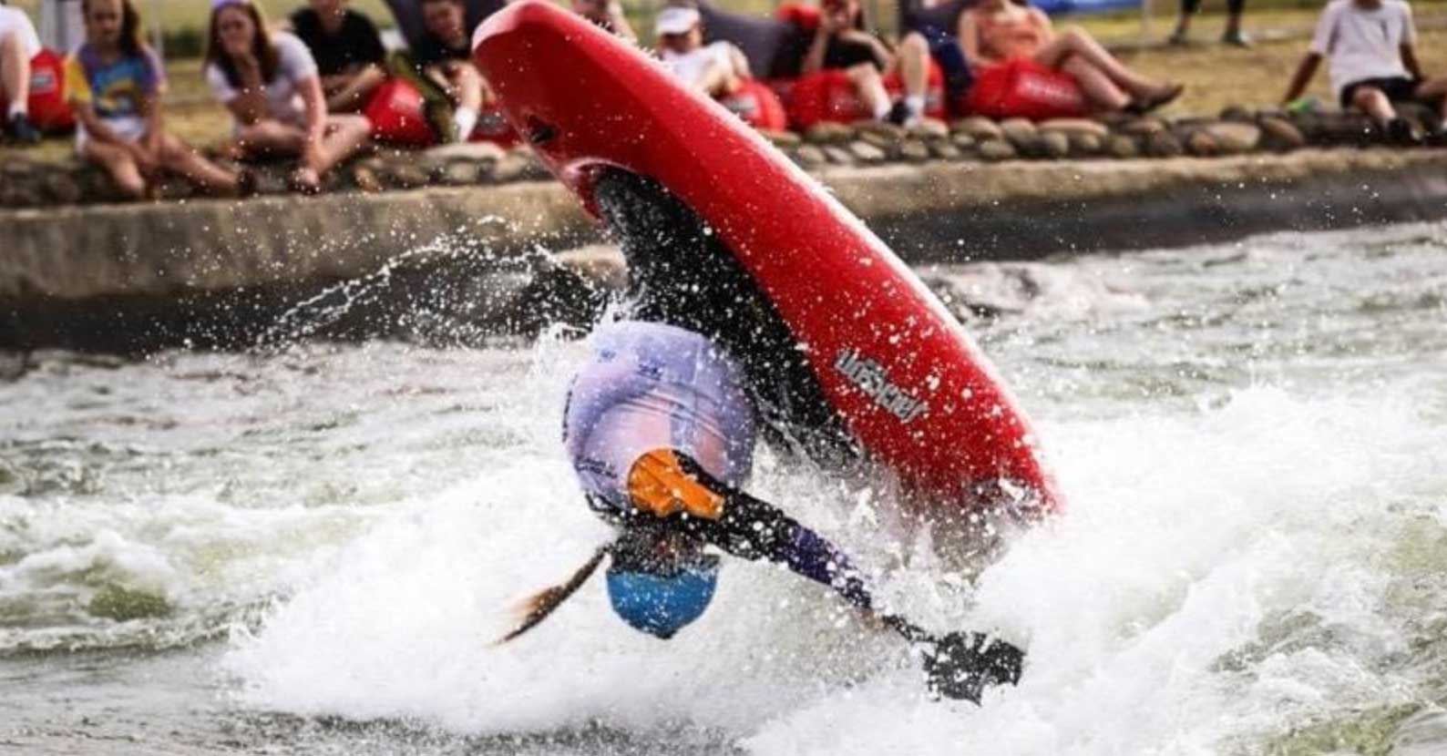 Doing a flip on a kayak in a whitewater competition