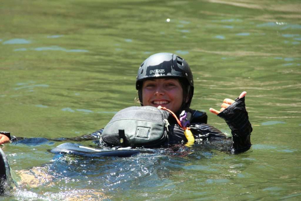 a little boy that is standing in the water