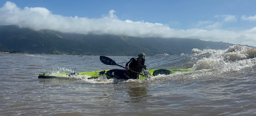 a person riding a surf board on a body of water